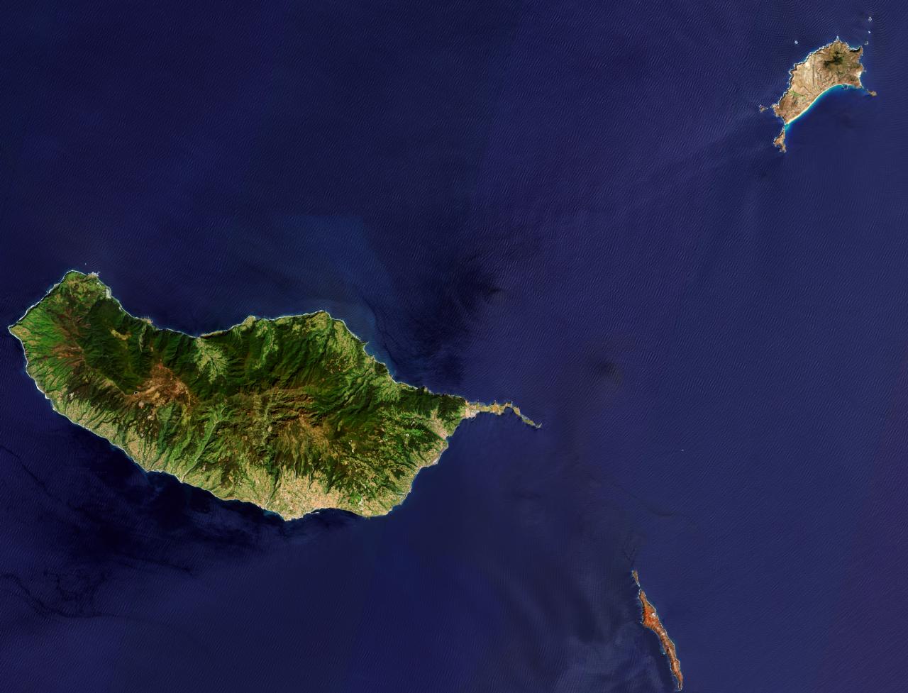 Satellite image of the Madeira archipelago by the Copernicus Sentinel-2 stellite, with Porto Santo on the top right, Madeira island on the center, and the Desertas islands at the bottom, with the Chão islet at the top and Deserta Grande island at the