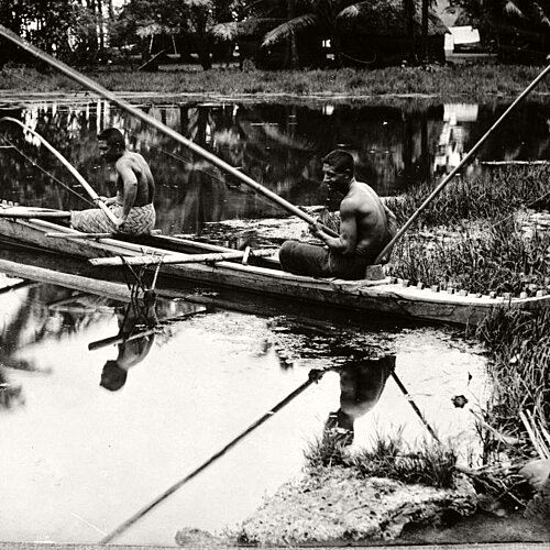 Two men fishing from canoe, 1914