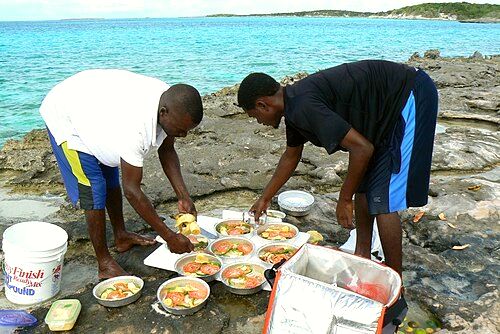 Men preparing a meal with caught fish