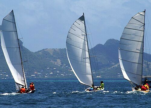 Local sailboats compete in regatta, Union Island in background