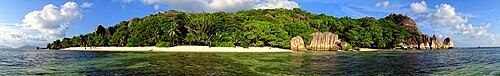 The beach and surrounding rocks at Anse Source d'Argent in the late afternoon.
