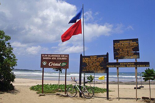 Beach sign and flag from the Bandera Azul Ecológica (Ecological Blue Flag) Program at Playa Langosta, Las Baulas National Marine Park, Guanacaste.