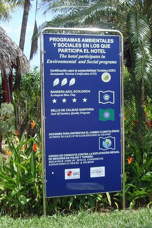 A hotel sign showing the voluntary certification programs the hotel has passed or is associated with. Shown are a four star Bandera Azul Ecológica and a three leaves CST Program.