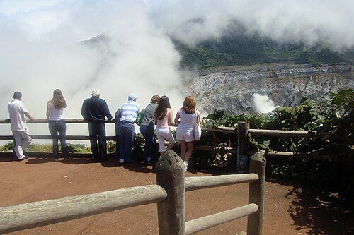 Tourists at the viewing area at the edge of the Poás Volcano crater.