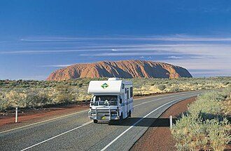Driving on the Lasseter Highway near the Uluṟu-Kata Tjuṯa National Park, a UNESCO World Heritage Site that highlights Australia's Aboriginal population